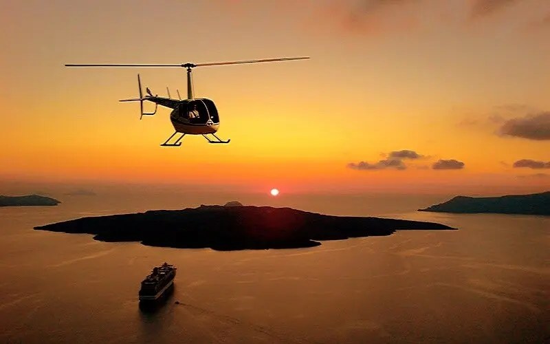 Helicopter Flight Over Santorini Caldera at Sunset